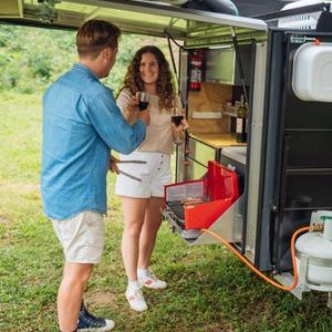 Couple under cover in Tear Drop Camper kitchen